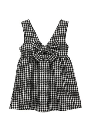 Robe sans manches à carreaux noirs et blancs avec un décolleté en V et un grand nœud décoratif à la taille, fabriquée en tissu texturé.