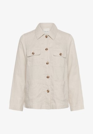 Beige vászonzakó, galléros nyakkal, elöl gombos záródással és két mellzsebbel. Lazább szabású, hosszú ujjak jellemzik.