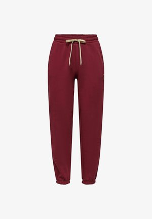 Pantalon de jogging bordeaux avec taille élastique, cordon de serrage crème, poches latérales et poignets élastiques aux chevilles.