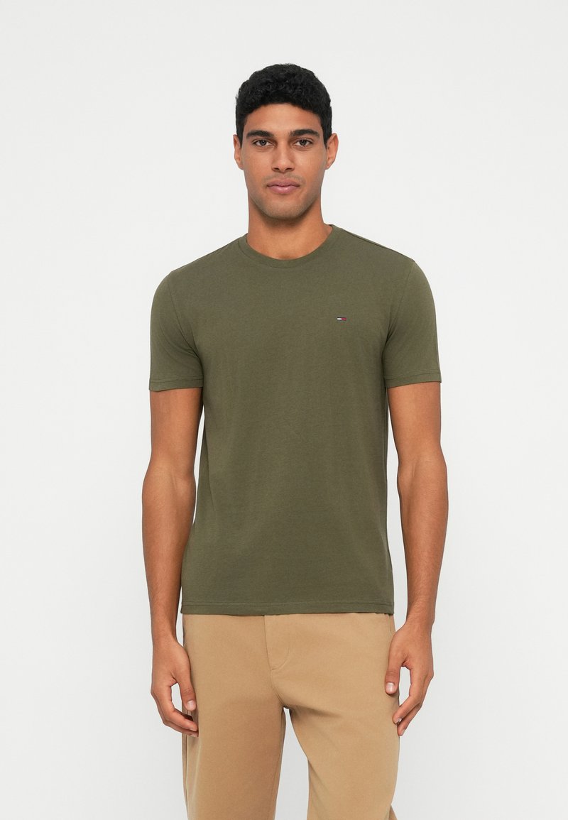 Olive green short-sleeve t-shirt with a crew neck and a small logo accent on the chest, made of soft fabric.