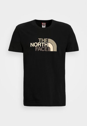 T-shirt en coton noir à manches courtes, avec un grand logo graphique doré et crème de "The North Face" sur le devant.