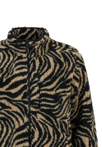 Veste polaire avec motif zèbre noir et beige, fermeture éclair à l'avant, poche poitrine et col montant.