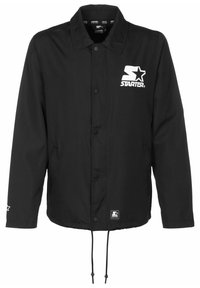 Veste noire à boutons avec col, logo Starter blanc sur la poitrine, petit écusson logo près de l'ourlet et cordons suspendus en bas.