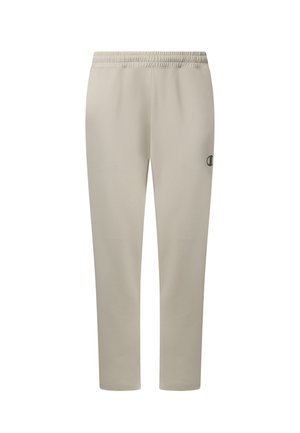 Pantaloni della tuta beige con vita elastica, gambe aderenti e un piccolo logo nero sulla coscia destra, mostrati su sfondo bianco.