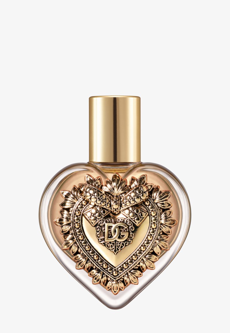 Hartvormige parfumfles met gouden decoratief embleem met strik en initialen "DG", met een gladde gouden dop.