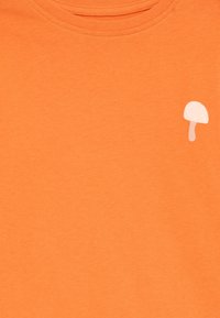 Orange cotton T-shirt featuring a small white mushroom graphic on the left chest area. Soft texture, crewneck design.