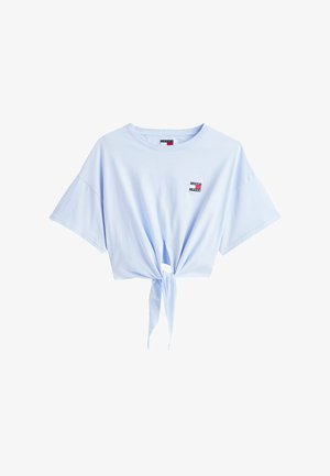 Light blue cotton t-shirt with short sleeves and a front knot detail, featuring a small logo patch near the neckline.