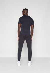 Reebok IDENTITY SMALL LOGO JOGGER - Donji dijelovi trenirke - black