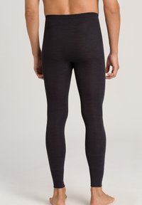 Sorte, tætsiddende leggings lavet af et strækbart stof. Har en høj elastisk talje og sømværkdesign langs benene.