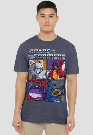 Navy blue cotton T-shirt featuring "Transformers" graphic, with four character panels in bold colors and comic-style outlines.
