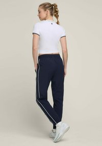 Wilson ACTION WARM-UP - Jogginghose - dunkelblau