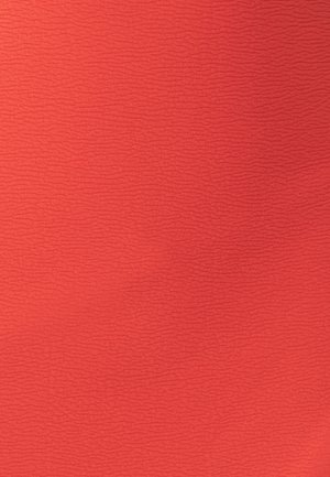 Tissu texturé de couleur corail vif, avec un motif en vagues à la surface, créant un design visuellement intéressant.