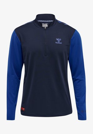 Marinblå långärmad skjorta med kvartdragkedja, blå detaljer på ärmarna och en liten logotyp på bröstet. Tillverkad av ett mjukt tyg.