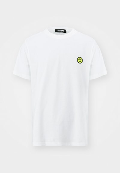 White cotton T-shirt with a round neck and short sleeves. Features a small, round black logo with a smiling face in neon yellow on the chest.