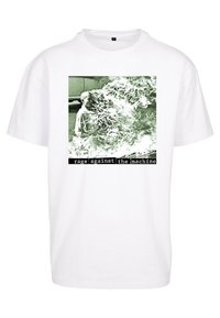 White cotton t-shirt featuring a square graphic in green tones, showing a figure with waves and text reading "rage against the machine" at the bottom.