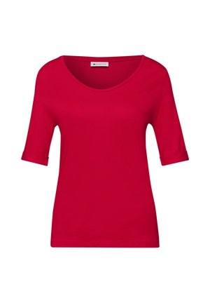 Chemisette rouge pour femme avec un col rond et des poignets de manches repliés sur un fond blanc uni.