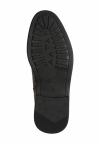 Semelle de chaussure en caoutchouc avec un motif de grip texturé, présentant une finition noire lisse et un marquage. Conçue pour l'adhérence et la durabilité.