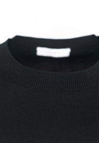 Maglione nero a maglia con scollo rotondo e texture a coste. Etichetta visibile all'interno dello scollo. Nessun motivo o dettaglio aggiuntivo.