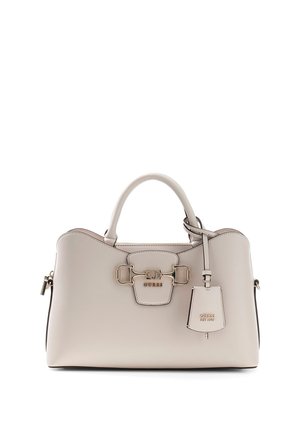 Beige leather Guess handbag with rounded handles, gold-tone hardware, and a hanging key tag embossed with the brand name.