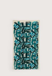 Tessuto con un motivo di forme geometriche in teal e verde scuro su uno sfondo crema chiaro. Il materiale appare intrecciato e morbido.