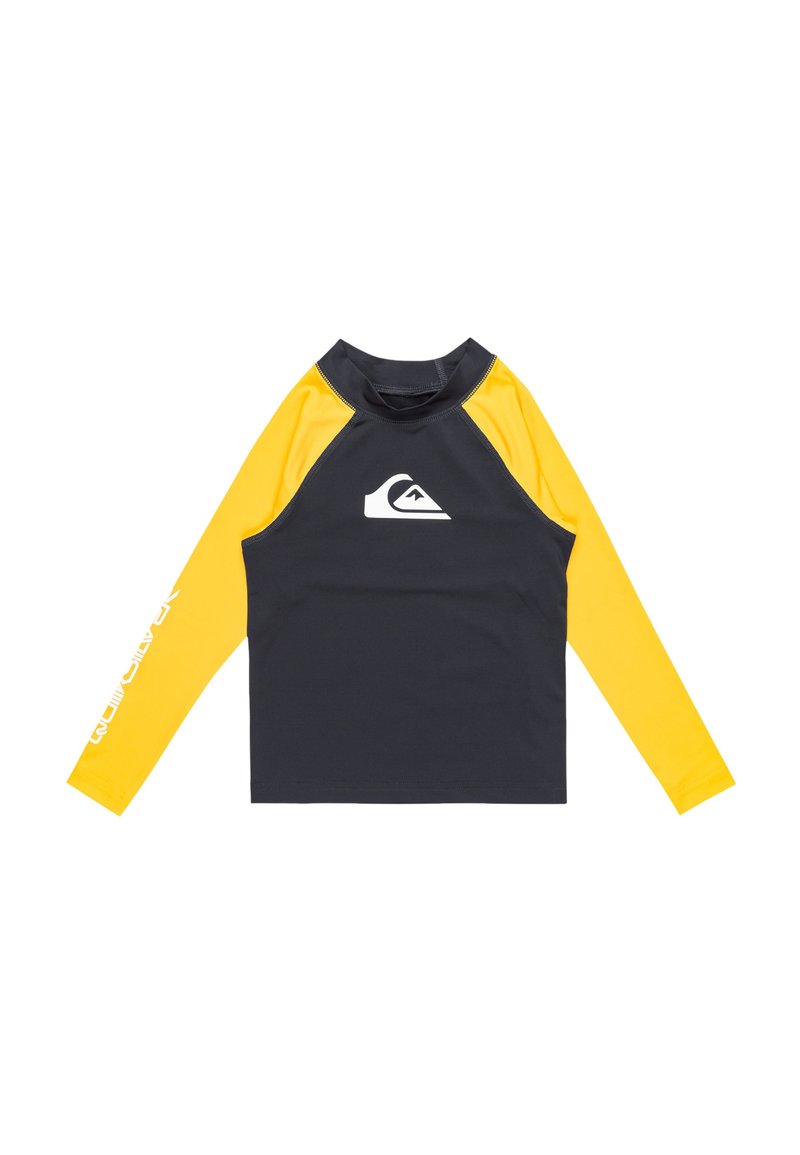 Långärmad rash guard i svart och gult, tillverkad i stretchtyg. Har en vit logotyp på bröstet och text på vänstra ärmen.