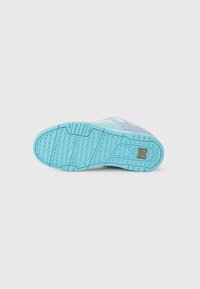Light blue sneaker sole with textured rubber, featuring a honeycomb pattern and a small logo. Upper shows a mix of blue and gray materials.