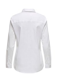 Blouse blanche à manches longues avec col, poignets boutonnés et couture au niveau du yoke dans le dos, vue de dos sur un fond uni.