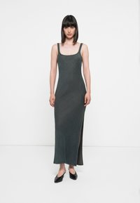 Sleeveless maxi dress in dark grey, featuring a square neckline, side slit, and decorative stitching along the straps and hem.