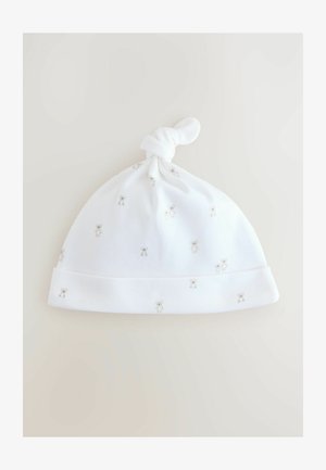 Weißer Baumwollbabyhut mit einem geknoteten Oberteil, der eine weiche Textur aufweist und mit kleinen Teddy-Muster in Hellgrau durchzogen ist.