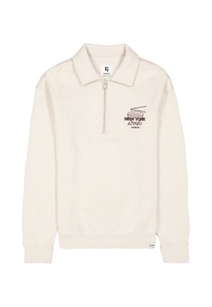 Pull beige à manches longues avec col, demi-zip devant et petit motif sur la poitrine portant l’inscription "New York" au-dessus d’une illustration de platine vinyle.