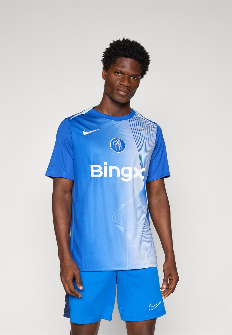 Blue Nike soccer jersey with a gradient design, featuring a logo and white text. Paired with matching blue shorts and a smooth texture.