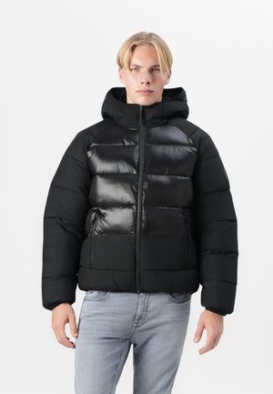 Black puffer jacket with a shiny finish, hood, zip closure, two front pockets, and panel design. Made of lightweight, insulated material.