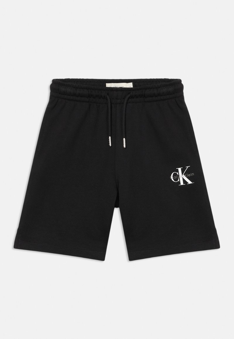 Black cotton shorts with an elastic waistband, adjustable drawstring, and a white logo on the left front side. Smooth texture, casual design.