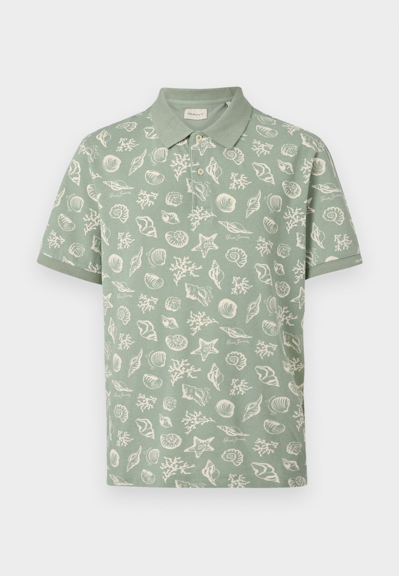 Polo a maniche corte verde salvia con motivi di conchiglie bianche, stelle marine e coralli, dotata di patta con bottoni e colletto piegato.