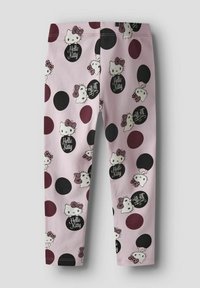 Różowe legginsy z powtarzającym się wzorem Hello Kitty, czarnymi i burgundowymi kółkami, o miękkiej i elastycznej teksturze materiału.