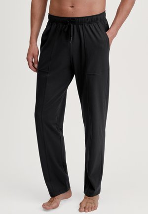 Black lounge pants with an elastic waist and drawstring, featuring side pockets and a smooth texture. Tailored fit and straight leg design.