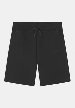 Black Nike shorts made of soft fabric, featuring an elastic waistband, drawstring, and two side pockets. Minimalist design with a logo accent.