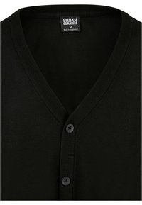 Cardigan negru dintr-un material moale, având un design cu decolteu în V, două butoane negre și accente cu nervuri în jurul gâtului și plachetei frontale.