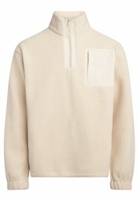 Κρέμα φλις μπουφάν με ψηλό κολάρο και μισό φερμουάρ, με πατσαριστή τσέπη με φερμουάρ στην αριστερή πλευρά του στήθους. Μαλακή υφή.