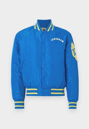 Zils universitātes žakets ar dzeltenām jostām. Ar izšūtu tekstu "ICECREAM" un logotipu. Izgatavots no gludas, spīdīgas auduma.