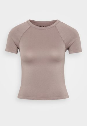 Różowa, dopasowana bluzka z krótkim rękawem, okrągłym dekoltem i rękawami raglanowymi. Wykonana z gładkiego, elastycznego materiału z minimalnymi detalami szwów.