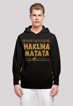 Black hoodie featuring "HAKUNA MATATA" in bold yellow text, accented with animal silhouettes and geometric patterns in red.