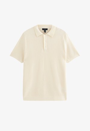 Polo a maniche corte color crema con motivo a maglia strutturata, patta con tre bottoni e colletto e polsini a costine.