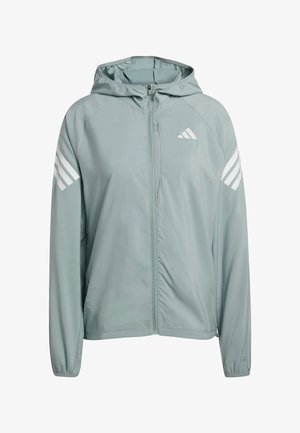 Lichtgrijze hooded jas van glad, lichtgewicht materiaal. Heeft witte strepen op de schouders en een ritssluiting aan de voorkant. Inclusief elastische manchetten.