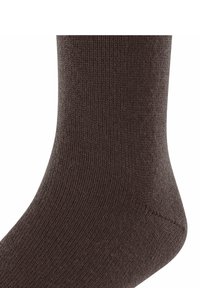 Calza marrone a costine con una texture liscia, caratterizzata da una punta arrotondata e una leggera elasticità nella parte superiore per una vestibilità sicura.