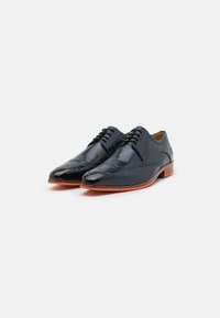 Scarpe in pelle blu navy con finitura lucida. Presentano dettagli brogue e suole in gomma arancione. Design classico con lacci.