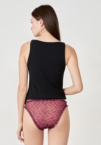 Black tank top with wide straps, paired with red floral patterned panties featuring a sheer texture and contrasting black trim along the edges.