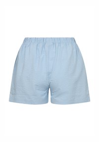 Light blue shorts made of textured fabric with an elastic waistband. Casual, loose-fitting design with side pockets.
