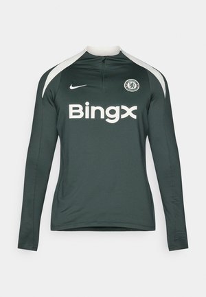 Langsleeve sportshirt in donkergroen met witte accenten. Voorzien van een ritssluiting in de hals, teamlogo en de merknaam "Bingx" in vetgedrukte witte tekst.