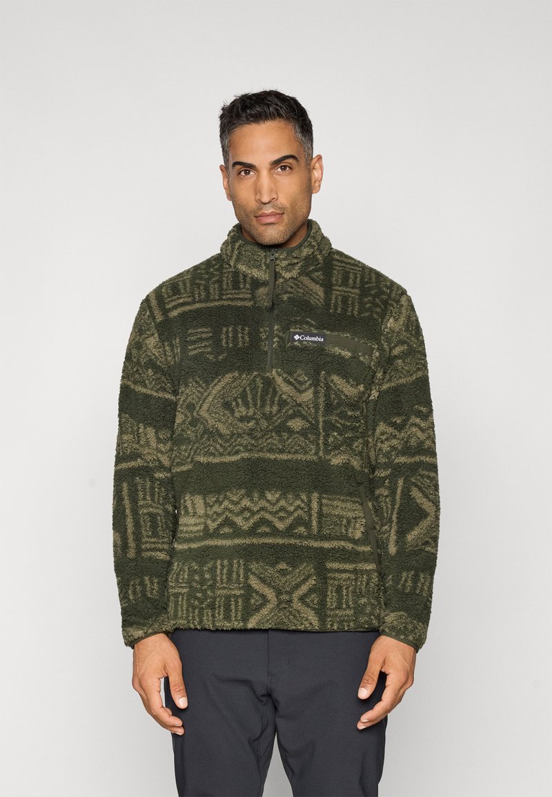 Fleece pullover in dark green with patterned texture and high collar. Features a half-zip front and a logo on the chest.